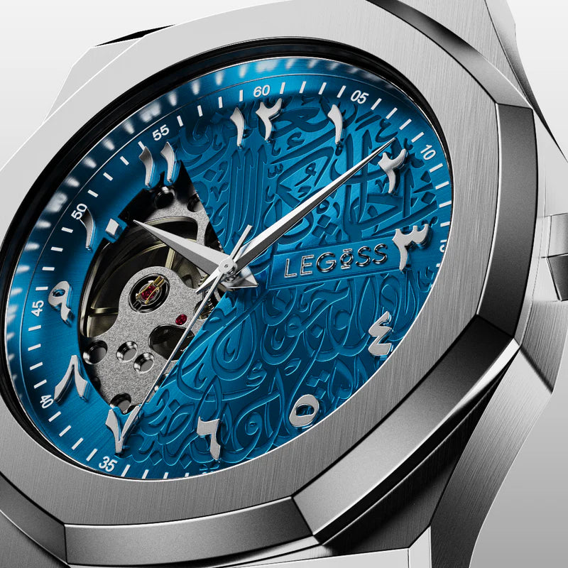 Close-up of the blue Arabic dial on a men’s automatic watch, showing intricate skeleton design